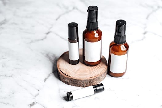 Stylish arrangement of amber skincare bottles on marble with wooden accent.